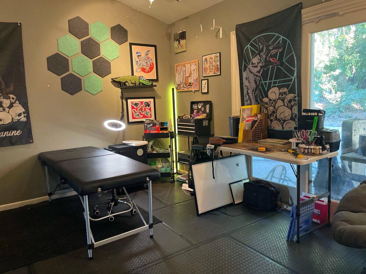 Tattoo studio with hexagonal acoustic panels and art wall