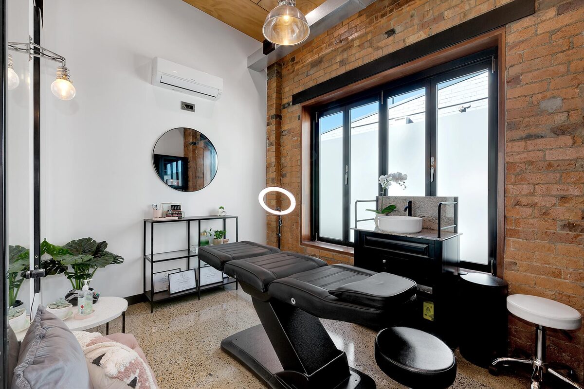 Esthetician suite with neon art and treatment bed