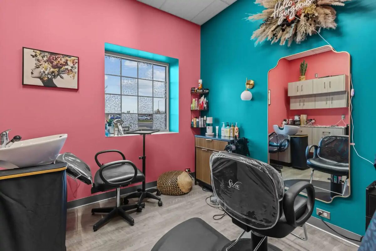 Colorful hair salon with pink and teal accent walls