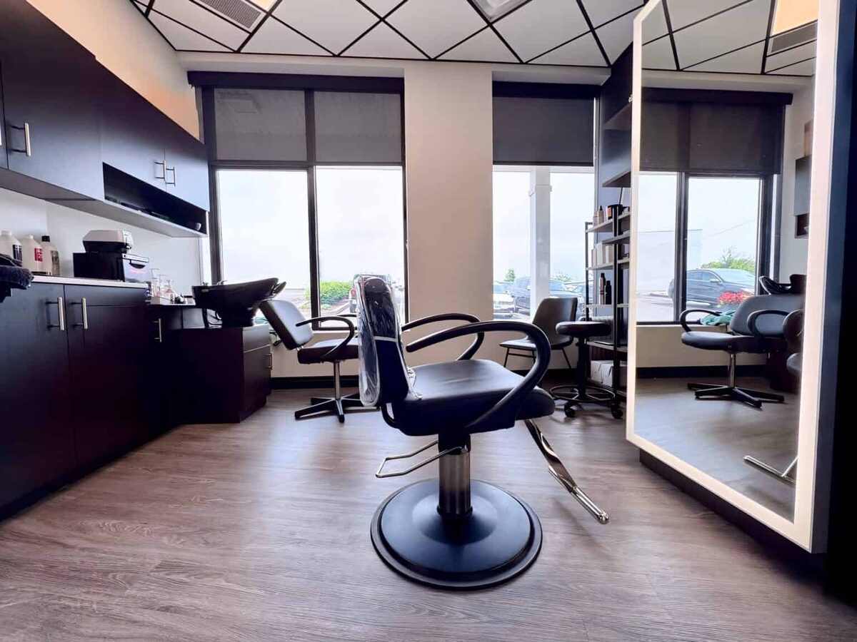 Dark modern hair salon suite with large LED mirror