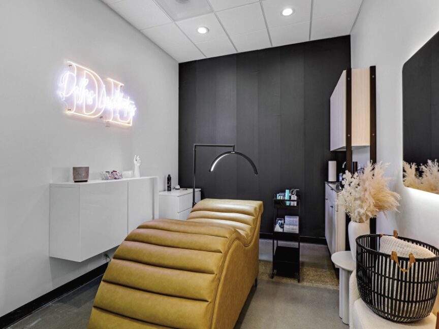 Warm-toned salon suite with shampoo bowl and styling chair